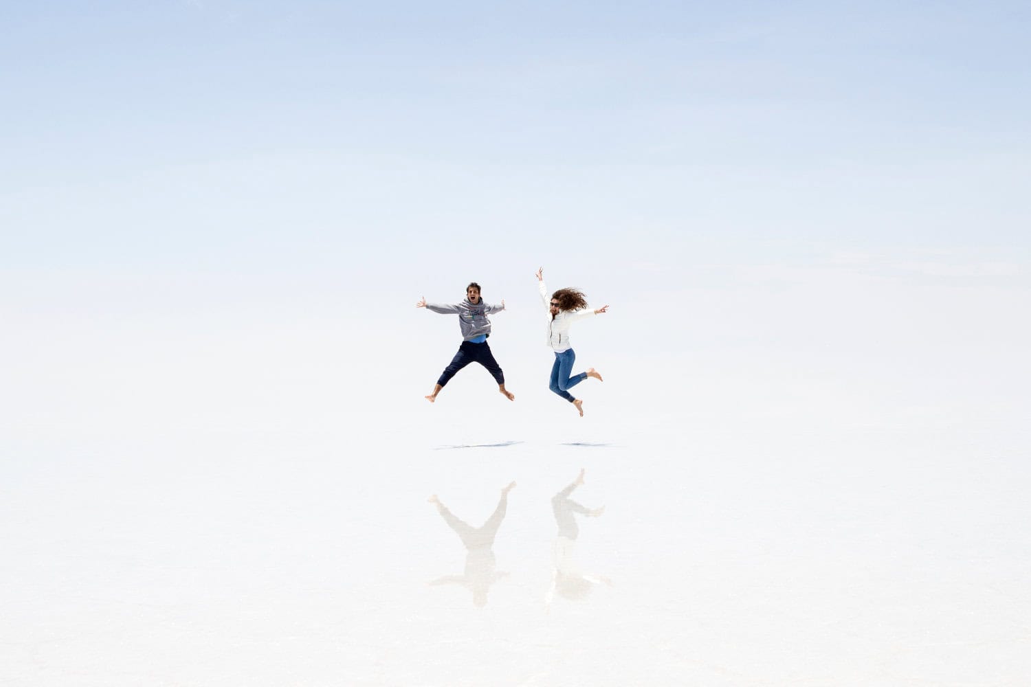 Young couple at Salar de uyuni salt flat in Bolivia